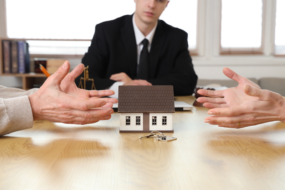 Mature couple dividing house at divorce lawyer's office